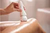 A hand holding a white electric epilator over a person's wet leg. Produktbild-Vorschau