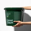 Hands holding a green bucket of Great Vita Zitronensäure powder. Produktbild-Vorschau