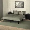 A bedroom scene with a bed, nightstands, and artwork. Podgląd zdjęcia produktu