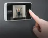 A hand is shown pressing the screen of a digital door viewer mounted on a wall. Produktbild-Vorschau