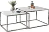 Two nesting coffee tables with white glass tops and chrome frames, set against a white background. Produktbild-Vorschau