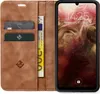 A brown leather flip case for a smartphone, with cards and money inserted. Produktbild-Vorschau