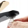 A close-up of a hand holding a coin to the aerator of a black and gold faucet. Anteprima dell’immagine prodotto
