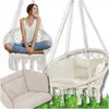 A collage of images showing a woman sitting in a hanging chair, another hanging chair with cushions, and a close-up of a cushion. Voir les images du produit