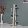 A tall, narrow plant stand with multiple shelves is shown against a gray wall. A white vase with dried branches is to the left. Anteprima dell’immagine prodotto