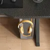 A pair of yellow headphones are hanging from a gaming desk. Produktbild-Vorschau