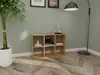 A wooden cube shelf unit with books and decorative items placed on it, next to a large potted plant and a floor lamp in a room with green walls and wooden flooring. Produktbild-Vorschau
