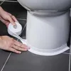 Hands applying white sealing tape around the base of a toilet. Anteprima dell’immagine prodotto