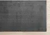 A close-up view of a gray rug on a light wooden floor. Produktbild-Vorschau