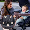 A woman and a baby in a stroller outdoors. Produktbild-Vorschau