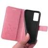 A hand holding open a pink flip phone case with a floral and butterfly embossed design. Produktbild-Vorschau