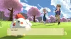 A cartoon-style image of a chicken with a speech bubble, and two people running in the background, set in a grassy field with cherry blossom trees. Produktbild-Vorschau