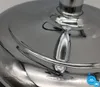 Close-up shot of the base of a silver standing fan, showing its reflective chrome surface and curved details. Produktbild-Vorschau