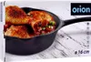 A box of Orion cast iron frying pan with chicken legs in it. Produktbild-Vorschau