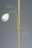 A close-up of a brass floor lamp with a flexible reading arm and a frosted glass shade. Produktbild-Vorschau