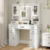 A white vanity table with a lighted mirror, drawers, and cabinets, set up in a room with a window and curtains. Podgląd zdjęcia produktu