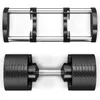 A top-down view of a set of adjustable dumbbells and their base. Produktbild-Vorschau