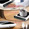 A coffee mug warmer with a cup of coffee on it, and a USB cable. Produktbild-Vorschau