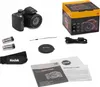 A collection of items related to a Kodak Pixpro AZ405 camera, including the camera itself, its box, batteries, a strap, a lens cap, a USB cable, and manuals. Náhled obrázku produktu