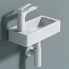 A white ceramic wall-mounted sink with a modern faucet and drainpipe against a light gray wall. Anteprima dell’immagine prodotto