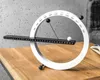 A modern magnetic calendar is displayed on a wooden table against a textured gray wall. Produktbild-Vorschau