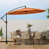 An outdoor dining set with a large orange cantilever umbrella providing shade. Produktbild-Vorschau
