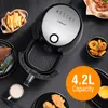 An overhead shot of an Aigostar air fryer with various food items arranged around it, including fries, onion rings, and fried chicken. Produktbild-Vorschau