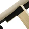 A close-up view of the corner of a bed frame, showing the fabric upholstery and a wooden support with velcro attached. Náhled obrázku produktu