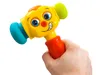 A hand holding a colorful toy hammer. Voir les images du produit