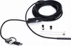 A black inspection camera with a long cable and USB connectors is laid out on a white background. Several small accessories are placed near the camera head. Náhled obrázku produktu