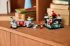 A small LEGO castle set with knights is displayed on a wooden surface, with books and a blue object in the background. Produktbild-Vorschau