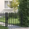 A black metal garden gate with spearhead finials is shown in front of a white house with a window and a lush green hedge. Náhľad obrázku produktu