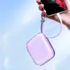 A hand holds a smartphone connected to a purple power bank with a lanyard, against a bright blue sky background. Anteprima dell’immagine prodotto