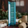A teal colored advent calendar filled with mini books, surrounded by Christmas decorations like pine branches, berries, and a gold ornament. Náhled obrázku produktu