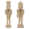Two unpainted wooden nutcrackers stand side-by-side against a white background. Produktbild-Vorschau