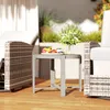 An outdoor patio scene with furniture and a small table holding fruit and flowers. Produktbild-Vorschau