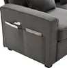 A close-up view of the side of a dark gray sofa, showing the armrest with integrated storage pockets. Voir les images du produit