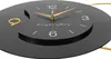 A close-up shot of a black wall clock with gold accents and hands. Anteprima dell’immagine prodotto
