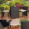 A patio furniture set with a table and two chairs, set in a garden with flowers. Anteprima dell’immagine prodotto