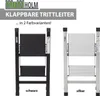Two foldable step stools, one black and one silver, are displayed side-by-side against a white background. Text above the stools indicates they are "KLAPPBARE TRITTLEITER" (foldable step stools) available in "2 Farbvarianten" (2 color variants). Produktbild-Vorschau