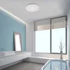 A modern bathroom with a large window, a bathtub, a sink, and a mirror. A ceiling light is visible. Produktbild-Vorschau