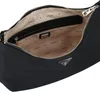 The inside of a black Guess hobo shoulder bag is shown. Produktbild-Vorschau