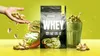 A product shot of protein powder with accompanying food items and a drink. Produktbild-Vorschau