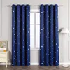 Two blue curtains with white and yellow stars are hanging in front of a window. A white nightstand with a framed picture and a small orange candle is to the left of the curtains. A white floor lamp is to the right. Produktbild-Vorschau