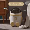A cute astronaut-shaped trash can is shown in a bathroom setting next to a wooden cabinet and a towel. Produktbild-Vorschau