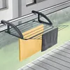 A drying rack attached to a balcony railing, with two towels hanging on it. Produktbild-Vorschau