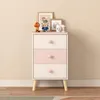 A children's dresser with three drawers, decorated with heart-shaped knobs, stands against a plain wall. Decorative items are placed on top of the dresser. Náhľad obrázku produktu