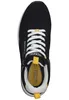 A top-down view of a black sneaker with white laces and yellow accents. Voir les images du produit