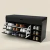 A black shoe cabinet with a padded seat on top, displaying various shoes on its pull-out shelves. Náhľad obrázku produktu
