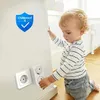A baby is interacting with a wall socket adapter. Produktbild-Vorschau